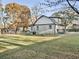 Large backyard with grassy lawn, mature trees, and a deck at 2933 5Th Sw St, Atlanta, GA 30315