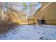 Winter backyard with an elevated deck and wooded surroundings at 3332 Fannin Ct, Lithonia, GA 30038