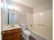 Bright bathroom featuring a shower-tub combo, single sink vanity, and modern fixtures at 3332 Fannin Ct, Lithonia, GA 30038