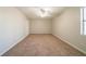Bright, carpeted bedroom with a ceiling fan and ample natural light from the window at 3332 Fannin Ct, Lithonia, GA 30038