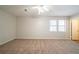 Large bedroom with neutral walls, ceiling fan, carpet, and natural light streaming through windows at 3332 Fannin Ct, Lithonia, GA 30038
