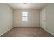 Bedroom with neutral walls, carpet, a window and white door at 3332 Fannin Ct, Lithonia, GA 30038