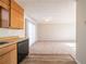 Open kitchen with wood cabinets and breakfast area with carpet at 3332 Fannin Ct, Lithonia, GA 30038