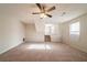Spacious living room with a ceiling fan, fireplace, and staircase to the second floor at 3332 Fannin Ct, Lithonia, GA 30038