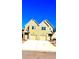 Two story townhome with neutral yellow siding, white trim, attached garage, and well-lit exterior at 3108-A Brownstone Se Ln, Atlanta, GA 30354