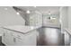 Open-concept floor plan featuring a kitchen island with granite countertops and view to a seating area at 3108-A Brownstone Se Ln, Atlanta, GA 30354