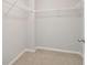 Walk-in closet with white wire shelving and neutral carpet at 3108-A Brownstone Se Ln, Atlanta, GA 30354