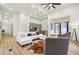 Open living room with light wood floors, sectional sofa, and marble accent wall at 1073 Mayson Turner Nw Rd, Atlanta, GA 30314