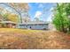 Spacious backyard with mature trees and a view of neighboring homes at 2899 Gresham Se Rd, Atlanta, GA 30316