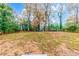 Open backyard with mature trees and partial view of the house at 2899 Gresham Se Rd, Atlanta, GA 30316