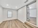 Bright basement room featuring wood-look floors and a window with blinds at 2899 Gresham Se Rd, Atlanta, GA 30316