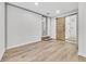 Spacious basement room with wood-look flooring and white brick accent wall at 2899 Gresham Se Rd, Atlanta, GA 30316