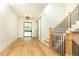 Bright entryway with hardwood floors, modern light fixture, and stylish barn door at 340 Colewood Way, Atlanta, GA 30328