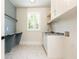 Laundry room with built-in cabinets and hexagon tile floor at 340 Colewood Way, Atlanta, GA 30328