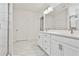 Bathroom with double vanity, marble tile, and walk-in shower at 590 Plainfield St, Fayetteville, GA 30215