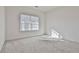 Simple bedroom with gray carpet, window with blinds, and bright natural light at 590 Plainfield St, Fayetteville, GA 30215