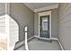 Green front door with glass panels and a welcome mat at 590 Plainfield St, Fayetteville, GA 30215