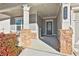 Front porch with stone columns and a green door at 590 Plainfield St, Fayetteville, GA 30215