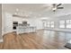 Open concept kitchen with white cabinets and island, hardwood floors at 590 Plainfield St, Fayetteville, GA 30215