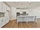 Modern kitchen with white cabinets, large island, and stainless steel appliances at 590 Plainfield St, Fayetteville, GA 30215