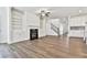 Open living room with hardwood floors, fireplace, and kitchen views at 590 Plainfield St, Fayetteville, GA 30215