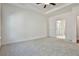 Bright bedroom with grey carpet and ensuite bathroom access at 590 Plainfield St, Fayetteville, GA 30215