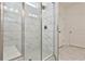 Large walk-in shower with marble tile and glass enclosure at 590 Plainfield St, Fayetteville, GA 30215