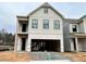 Two-story home with gray siding, black windows, and a two-car garage at 1074 Crest Mill Dr, Marietta, GA 30008