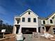 Two-story house under construction, beige siding, black windows, and a two-car garage at 1074 Crest Mill Dr, Marietta, GA 30008