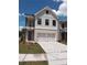 Charming two-story home with a brick facade, covered porch, and a two-car garage at 1074 Crest Mill Dr, Marietta, GA 30008
