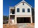 Two-story house with beige siding, brick bottom, and a two-car garage at 1074 Crest Mill Dr, Marietta, GA 30008