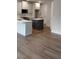 Contemporary kitchen with island and stainless appliances with new floors at 1074 Crest Mill Dr, Marietta, GA 30008