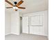 Carpeted bedroom features a ceiling fan and built-in storage at 2965 Ivy Mill Dr, Buford, GA 30519