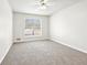 Carpeted bedroom features a ceiling fan and a window for lots of light at 2965 Ivy Mill Dr, Buford, GA 30519