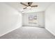 Carpeted bedroom features a ceiling fan and a window for lots of light at 2965 Ivy Mill Dr, Buford, GA 30519