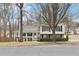 Inviting two-story home with a classic porch, featuring black shutters and complemented by mature trees and simple landscaping at 2965 Ivy Mill Dr, Buford, GA 30519