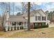 Charming home featuring a covered porch, brick accents, and well-maintained landscaping at 2965 Ivy Mill Dr, Buford, GA 30519