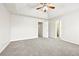 Bright main bedroom featuring a ceiling fan, neutral walls and plush gray carpeting at 2965 Ivy Mill Dr, Buford, GA 30519