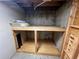 Unfinished basement storage with plywood shelving at 75 Briar Patch Rd, Covington, GA 30014