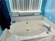 Bathroom with updated vanity and oval soaking tub at 75 Briar Patch Rd, Covington, GA 30014