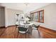 A beautifully decorated dining room features wood floors, a modern chandelier, and large window with wooded views at 4211 Burnt Hickory Nw Rd, Marietta, GA 30064