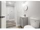 Neutral bathroom has a single vanity, wood floors, toilet, and access to hallway at 358 Roy Sw St, Atlanta, GA 30310