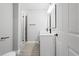 Modern bathroom features a double vanity, quartz countertop, and tiled shower with a glass door at 358 Roy Sw St, Atlanta, GA 30310