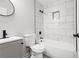 Clean bathroom features a shower and bath tub, as well as tiled walls at 358 Roy Sw St, Atlanta, GA 30310