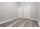 Well-lit bedroom with gray walls, wood-look floors, and double closets at 358 Roy Sw St, Atlanta, GA 30310