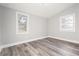 Bright bedroom with gray walls, wood-look flooring, and two windows at 358 Roy Sw St, Atlanta, GA 30310