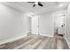 Empty bedroom with gray wood flooring, white trim, ceiling fan and en-suite bath at 358 Roy Sw St, Atlanta, GA 30310