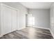 Spacious bedroom featuring gray walls, wood-look floors, and double doors to closet at 358 Roy Sw St, Atlanta, GA 30310