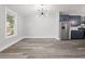 Well-lit dining area with a modern chandelier and view of the kitchen with stainless appliances at 358 Roy Sw St, Atlanta, GA 30310