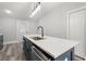 Features kitchen island with a sink, stainless steel appliances, grey cabinets, and sleek countertops at 358 Roy Sw St, Atlanta, GA 30310